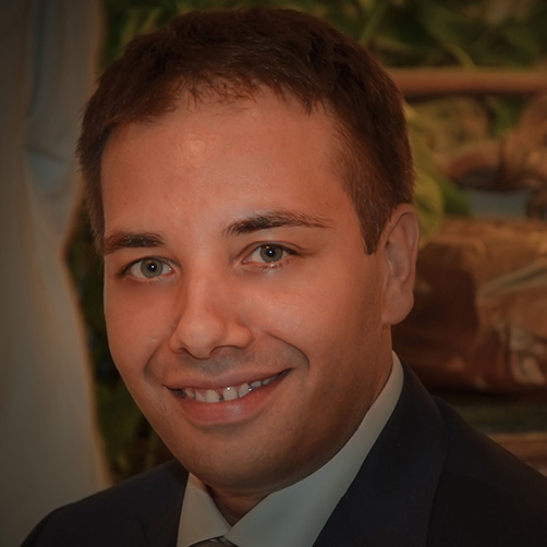 Happy businessman with laptop smiling
